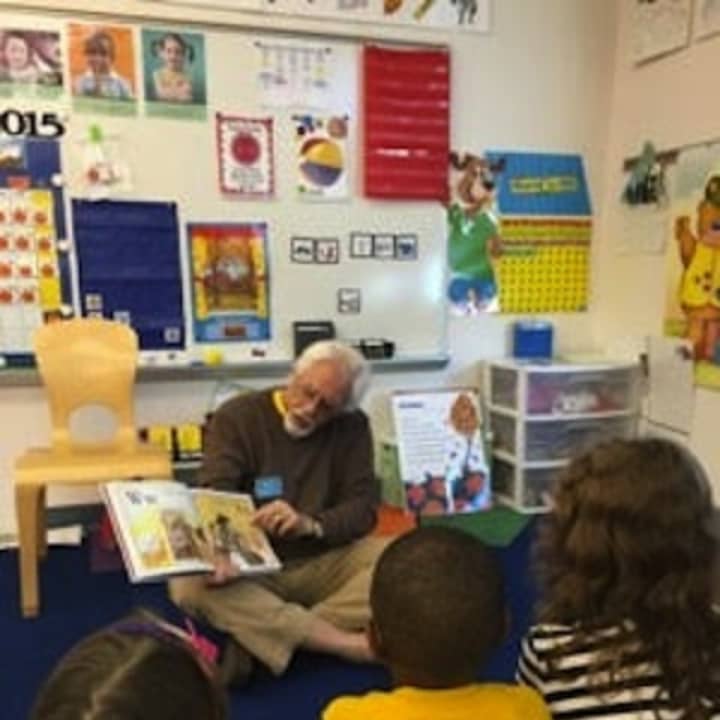 Daily Voice Community adviser Roy Fuchs reads to a class at Trumbull Early Childhood Education Center.