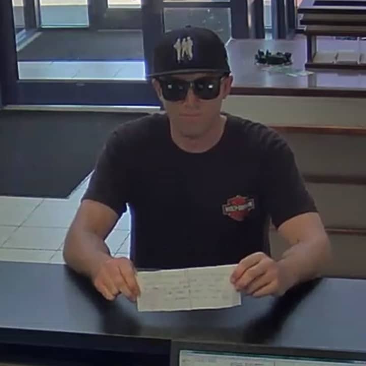 New York State Police are looking for this bank robbery suspect, seen on camera, who allegedly passed a note to a teller at TD Bank in Fishkill demanding money.