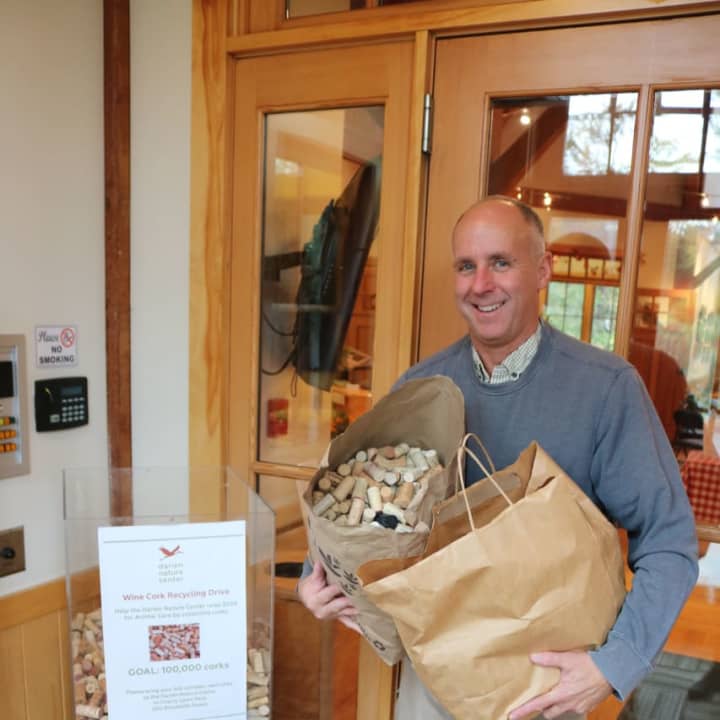 Tim Smith of WinePort of Darien drops off a donation of corks at the Darien Nature Center.