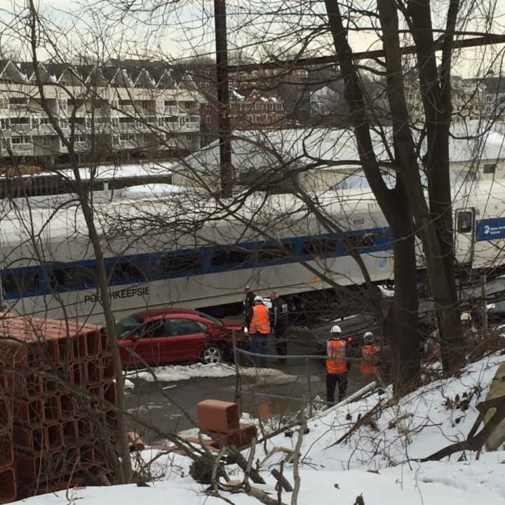 A Danbury-bound train slammed into a car on the tracks at a private grade crossing in Central Norwalk on Tuesday afternoon.