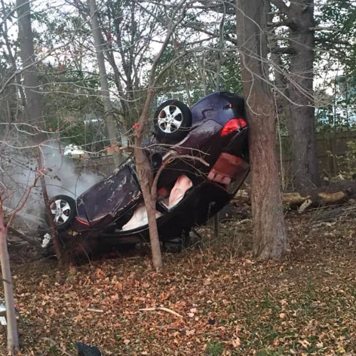 A car flipped over and its engine caught fire after a crash in Trumbull on Monday