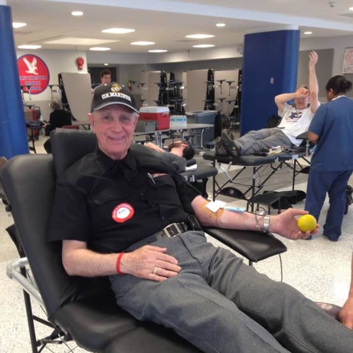 Eastchester native Joseph &quot;Joe&quot; Mamanna donating his 100th pint of blood at a community blood drive hosted by local school government.