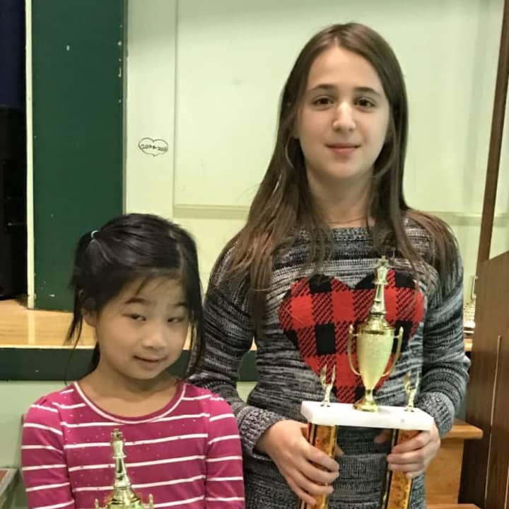 Scarlett Chen from Seely Place School in Scarsdale and Sophie Surguladze from Main Street School in Irvington display their trophies won in a recent chess tournament. The next tournament is Saturday in New Rochelle.