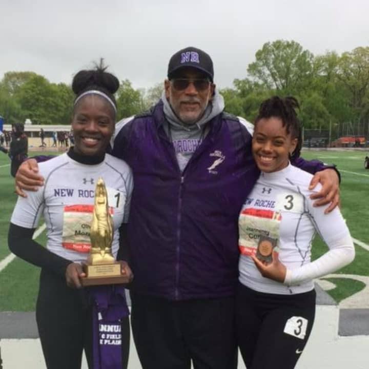 Olivia Morgan (left) and Jeanneney Currie (right) pose with their coach, Andy Capellan (center).
