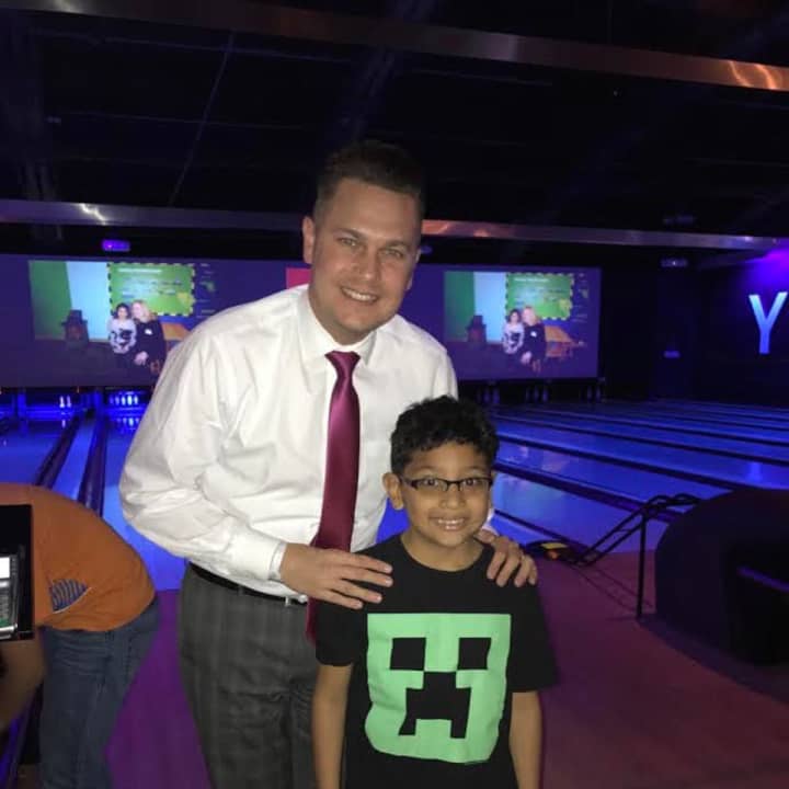 Brandon Oldham of Norwalk, mentor in the program, with his mentee, Ulysses, enjoy bowling.