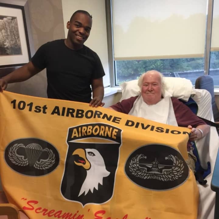 Army Pfc. Kevin Irving has made it a habit to come visit veterans in New Rochelle. He recently presented his friend John with a flag from his 101st Airborne Division.