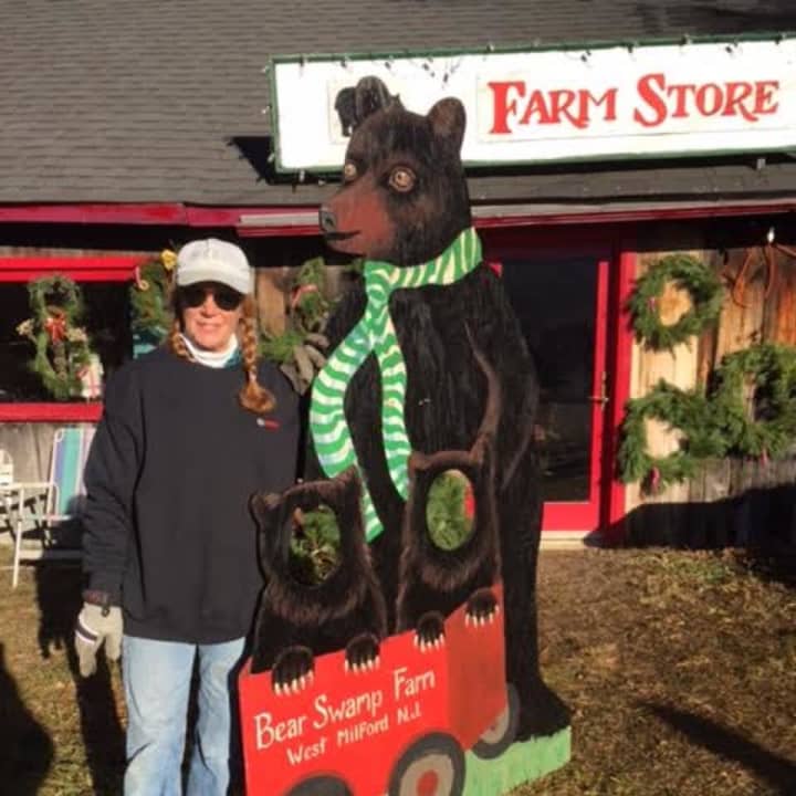 Allison Hosford&#x27;s sister Peggy Masce in front of the Bear Swamp gift shop with the bear she created.