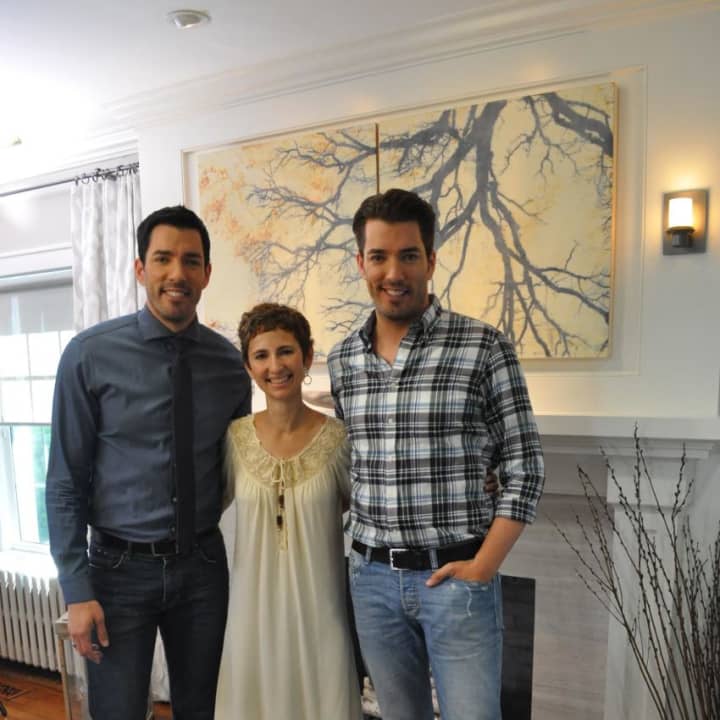Larchmont resident Kim Mitchell, center, with the Property Brothers Drew Scott, to her left, and Jonathan Scott on right.