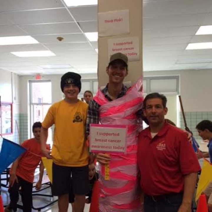 Students duct tape teachers to the wall for cancer research fund