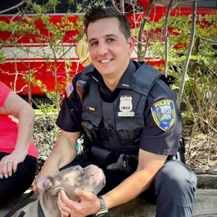 Ossining Police Officer Jason DaSilva is pictured with Cujo, who he rescued from a burning apartment building.
