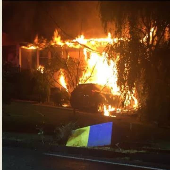Pearl River firefighters battled a large fire after an SUV slammed into the home, hitting a gas main.
