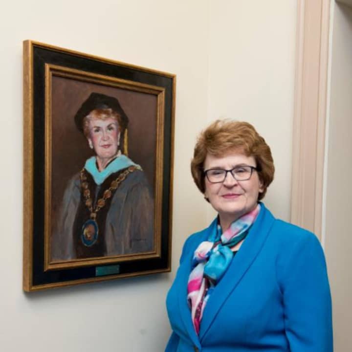 Dr. Martha Shouldis with her portrait at the unveiling at St. Vincent&#x27;s College in Bridgeport.