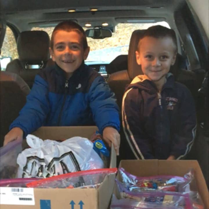 Daneen Mancuso&#x27;s two kids Matthew and Justin fill their car with candy that is being donated to veterans.