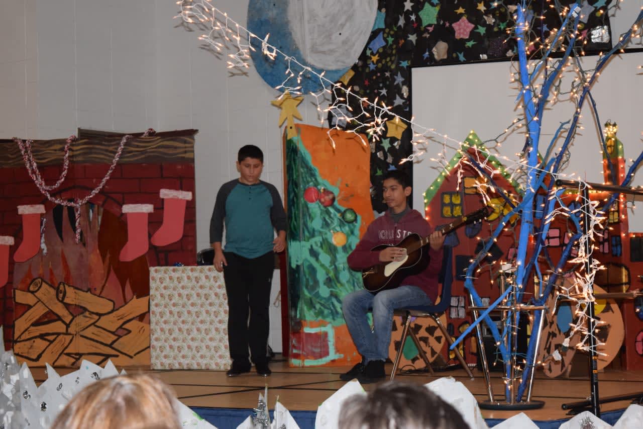Evan Cardillo tap dances while Brandon Isocoa plays guitar during the Pines Bridge and Walden Schools Holiday Spectacular on Friday, Dec. 23.