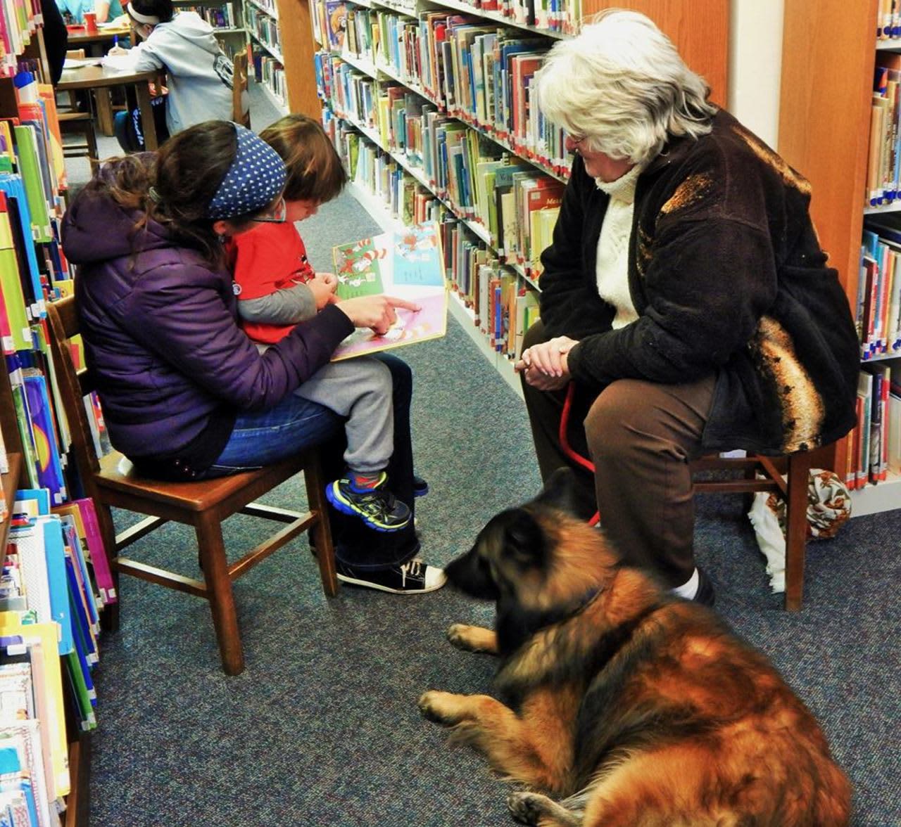 Kids read to a dog at the Pompton Lakes Library.