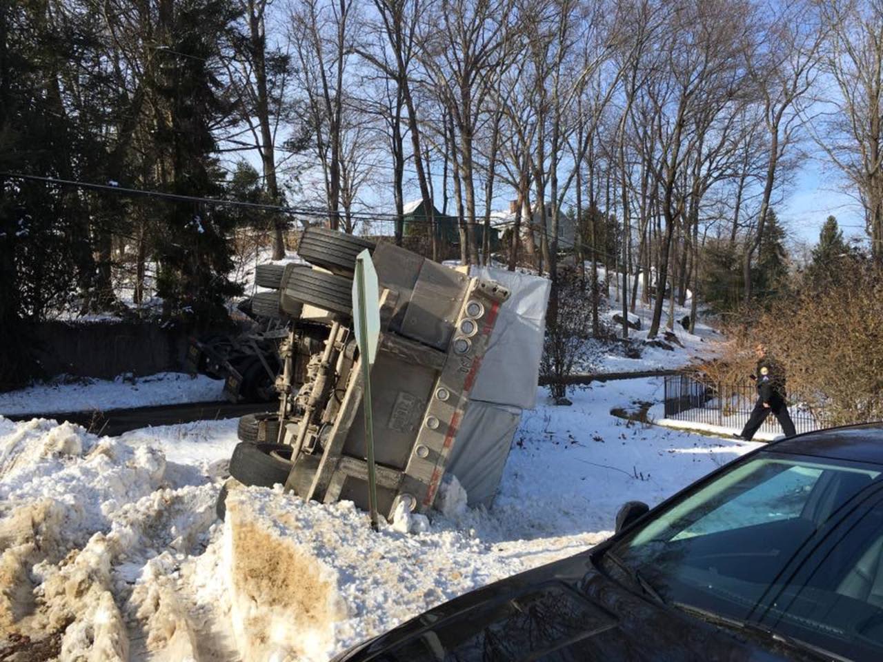 A tractor-trailer rolls over in the snow on Nashville Road in Bethel on Monday.