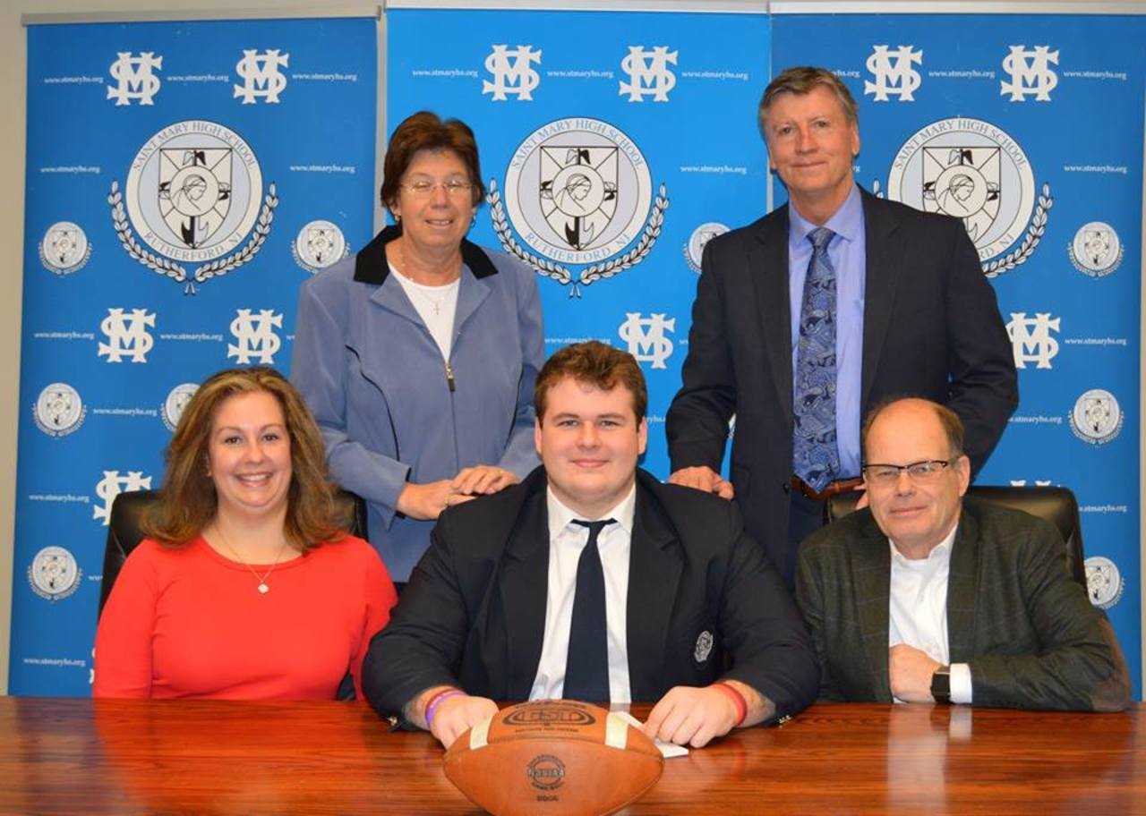 Logan Gardner with his parents, coach and principal