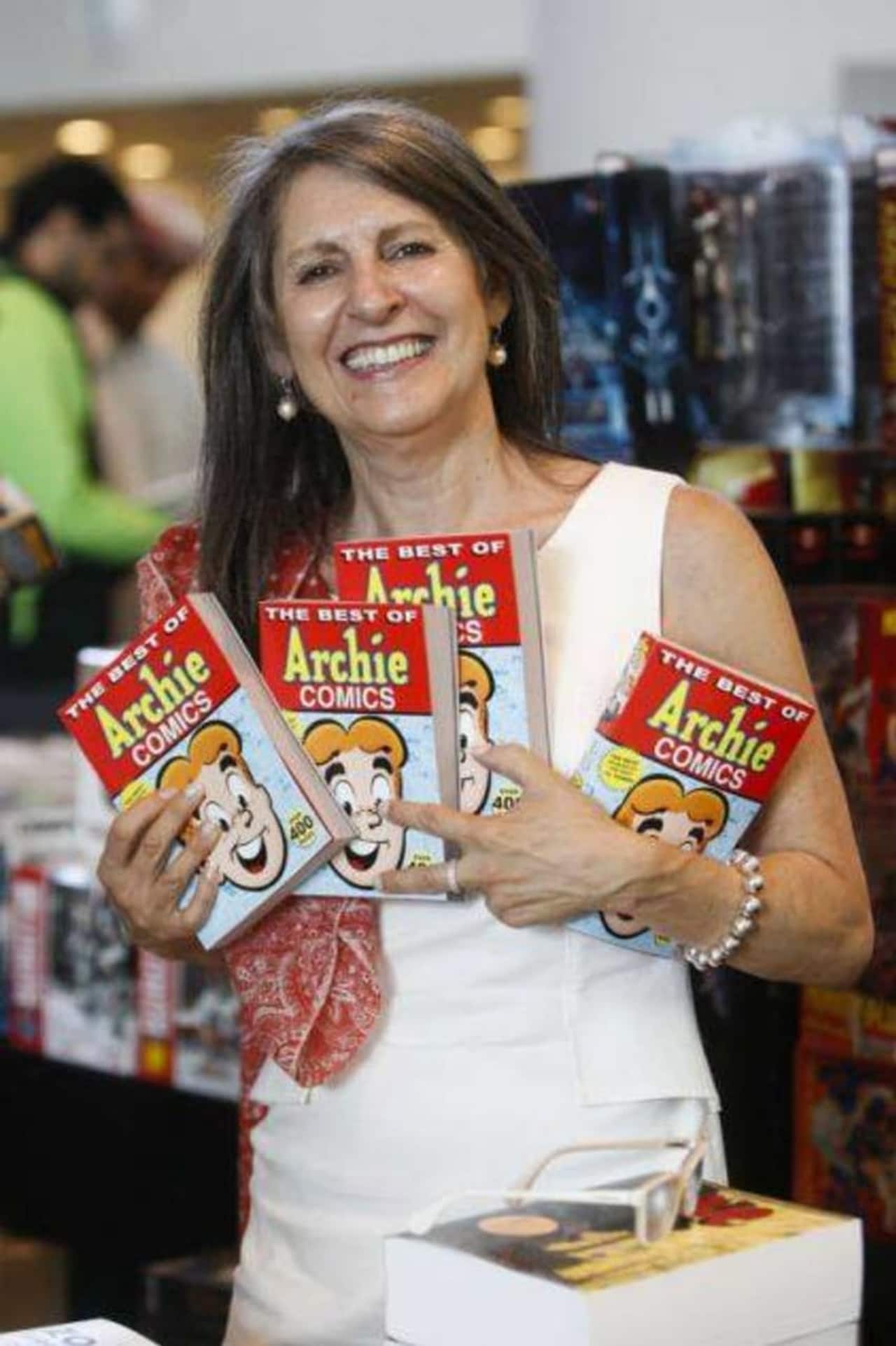 Nancy Silberkleit, publisher and co-CEO of Archie Comics, poses next to a sign proclaiming some of her comic book mottos.
