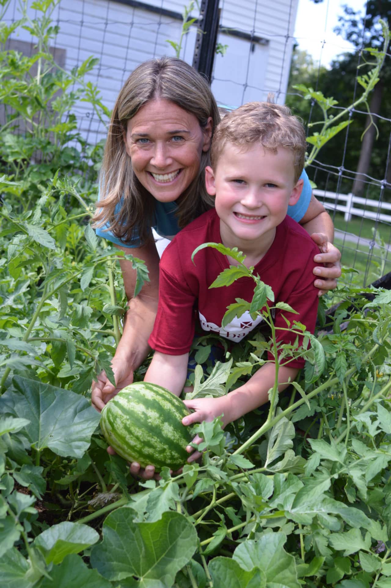 Ridgewood HealthBarn's Stacey Antine and camper Russ Romond of Wyckoff with the garden's first ever watermelon.