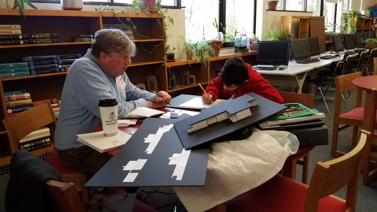 Bob Everett and mentee, Angel, working together on an architecture project, as part of the Norwalk Mentor Program.