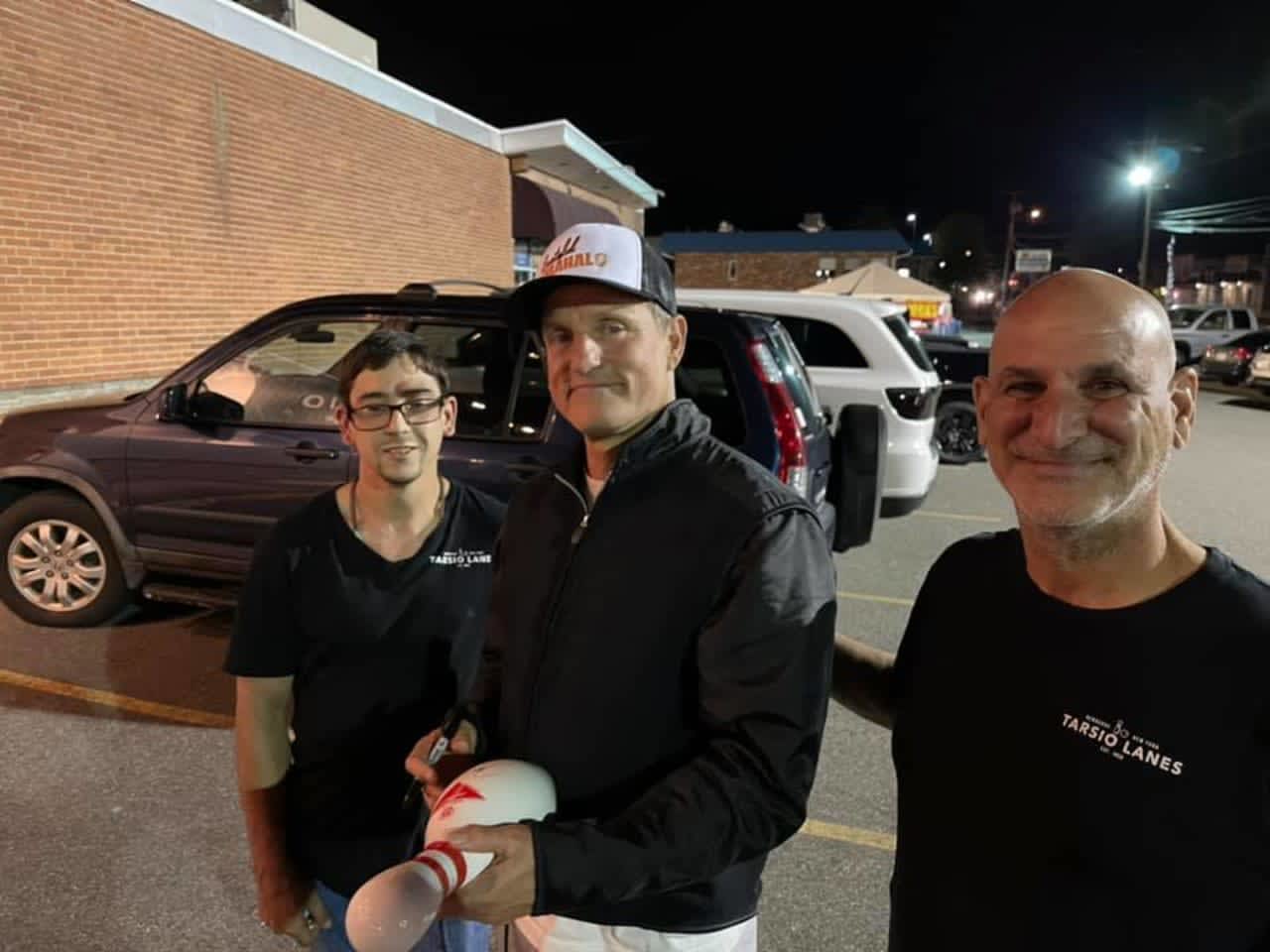 Woody Harrelson with Larry Perlitz and fans at the bowling alley.