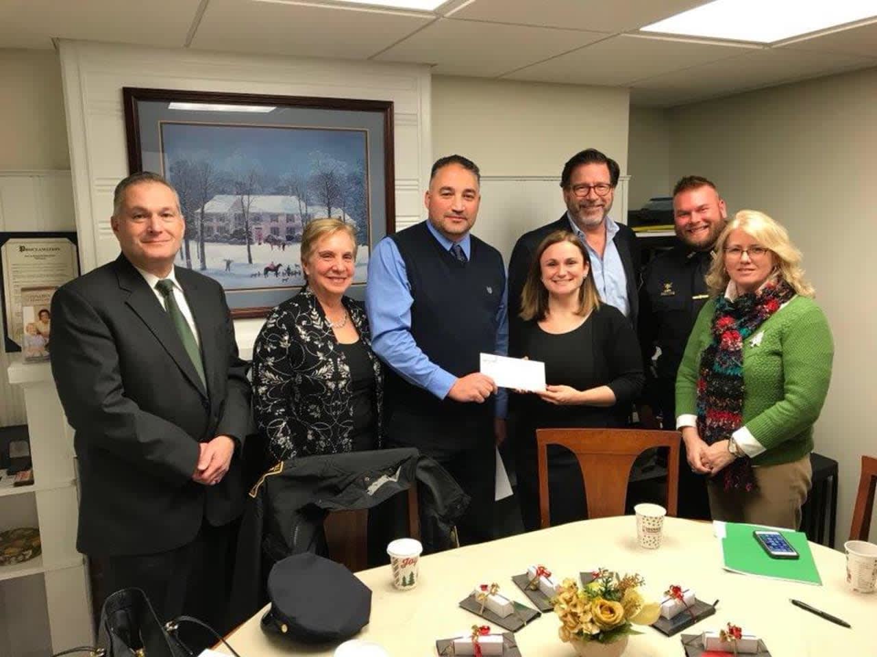 The Trumbull Police Union makes a donation to the Mary J. Sherlach Counseling Center. See story for IDs.