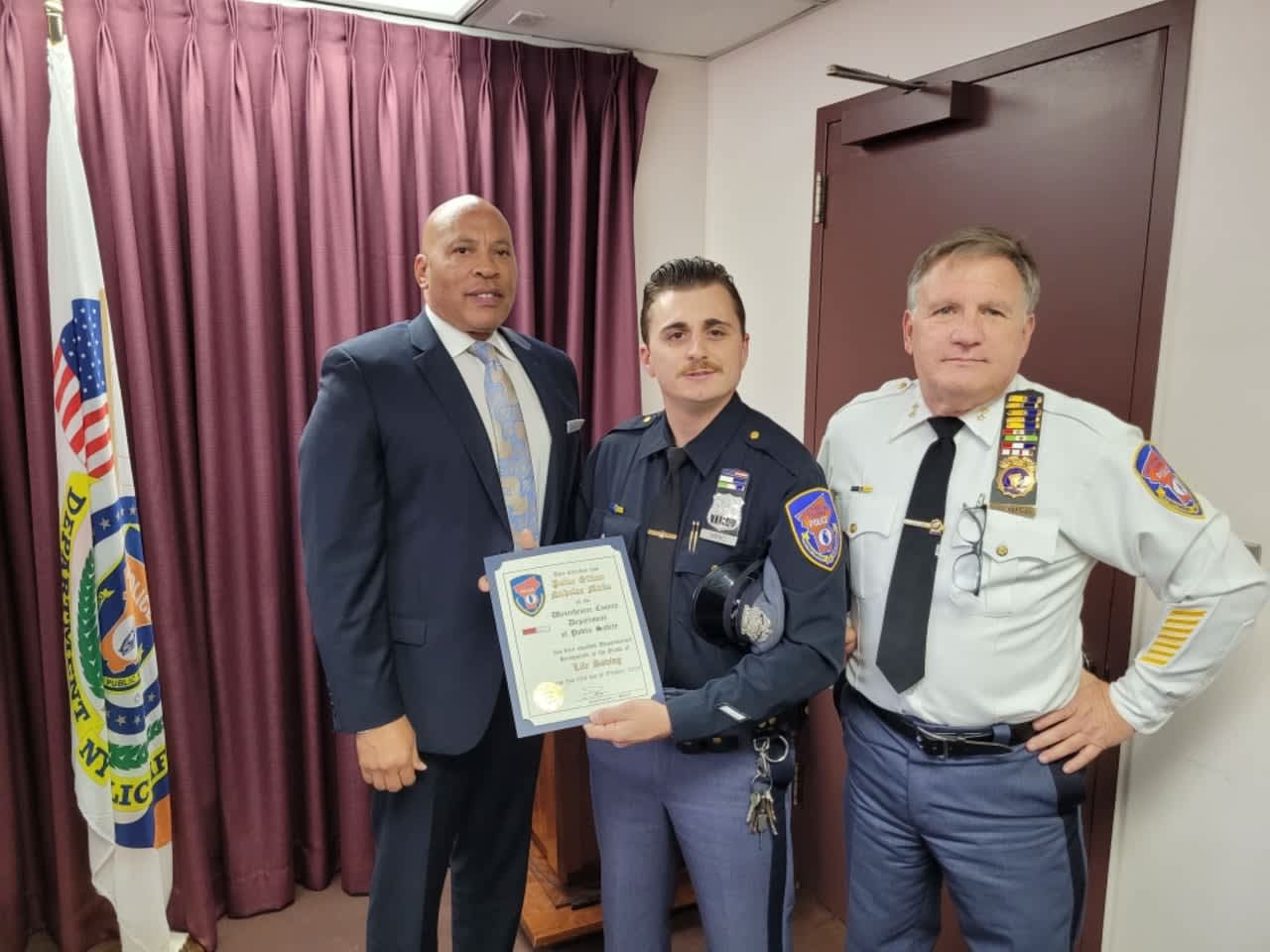Officer Nicholas Mirko (center) of the Westchester County Police Department accepts a Lifesaving Medal on behalf of himself and Sgt. Michael Ritell.