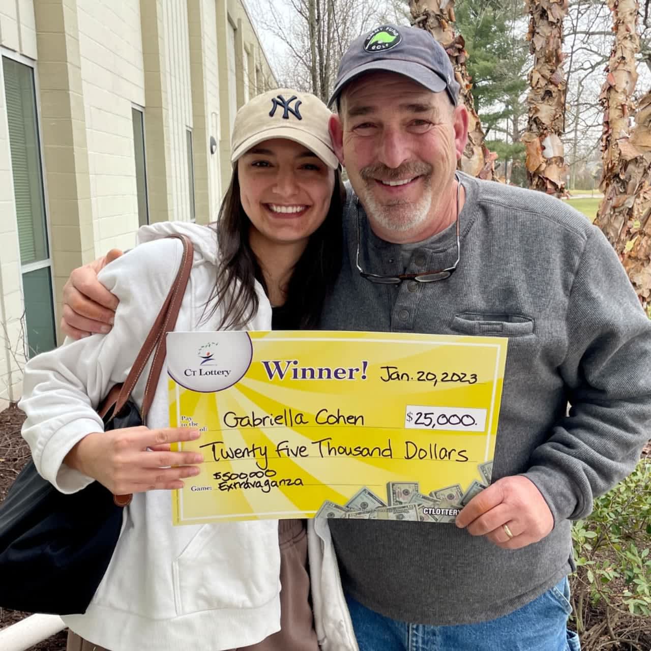 Gabriella Cohen and her father, Charlie LaMothe, claim Cohen's $25,000 prize from Connecticut Lottery.