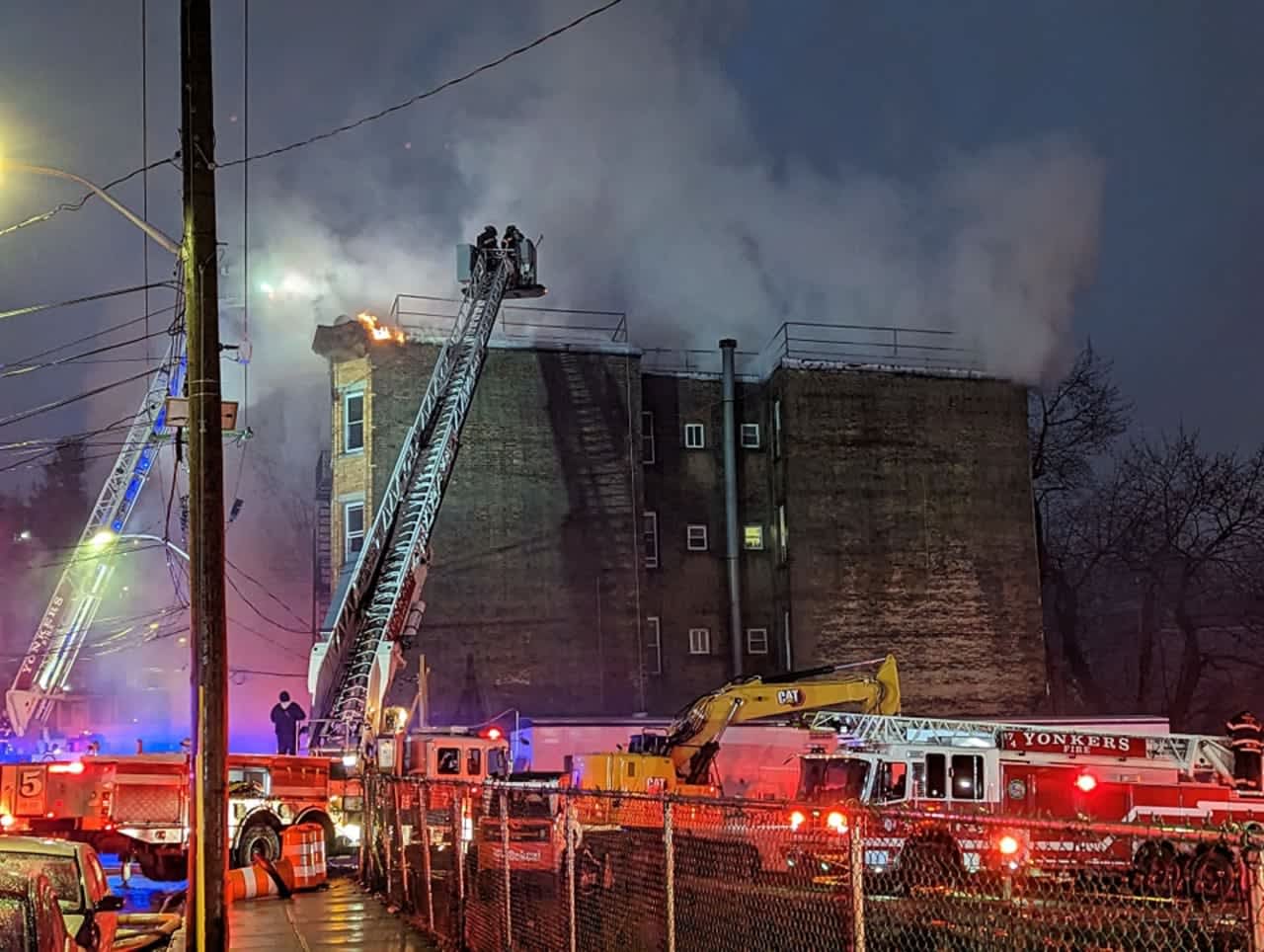 Firefighters battle a blaze in Yonkers at an apartment building at 21 Mulberry St.