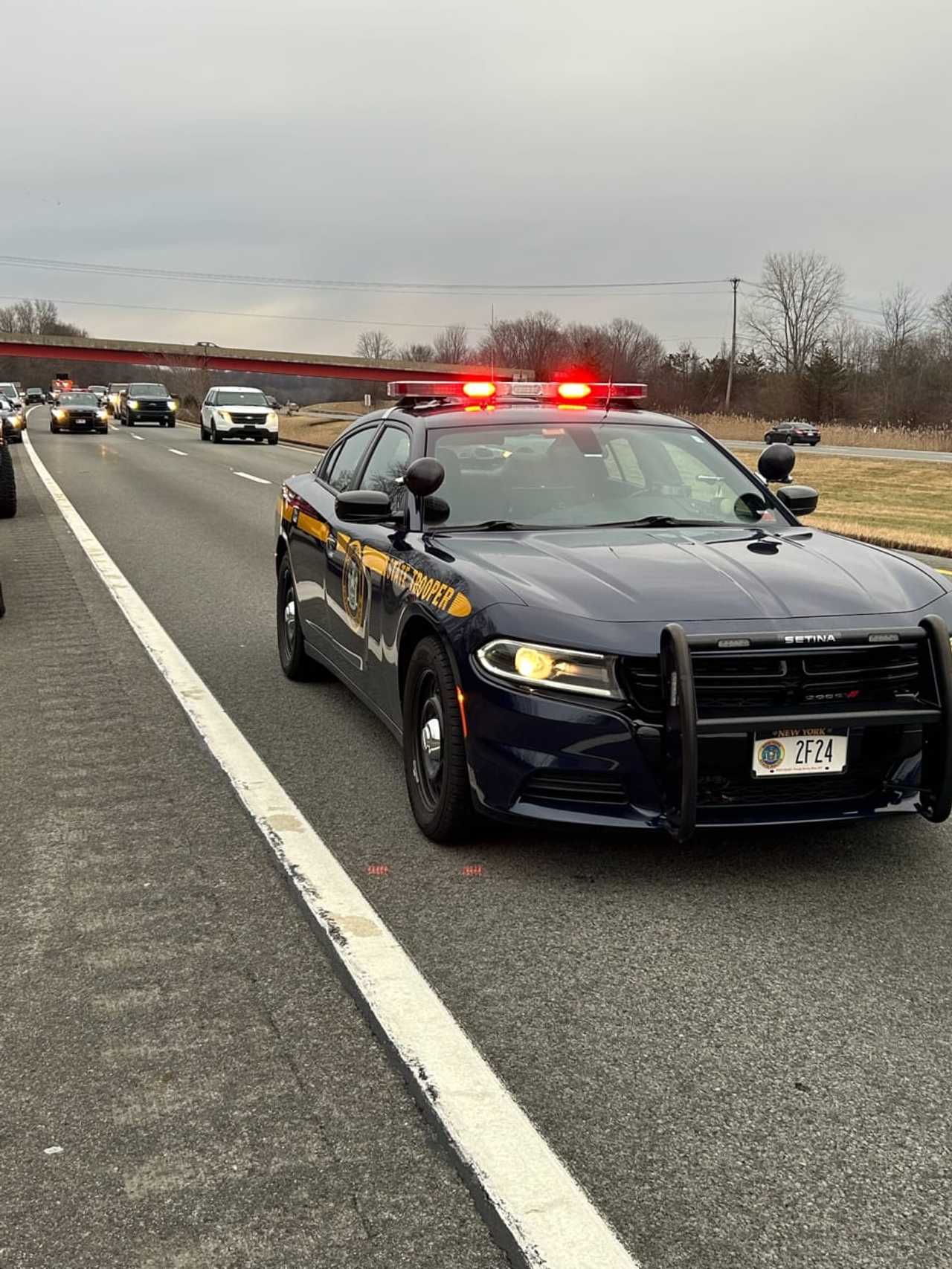 A New York State trooper monitors traffic in the area of the fatal crash.