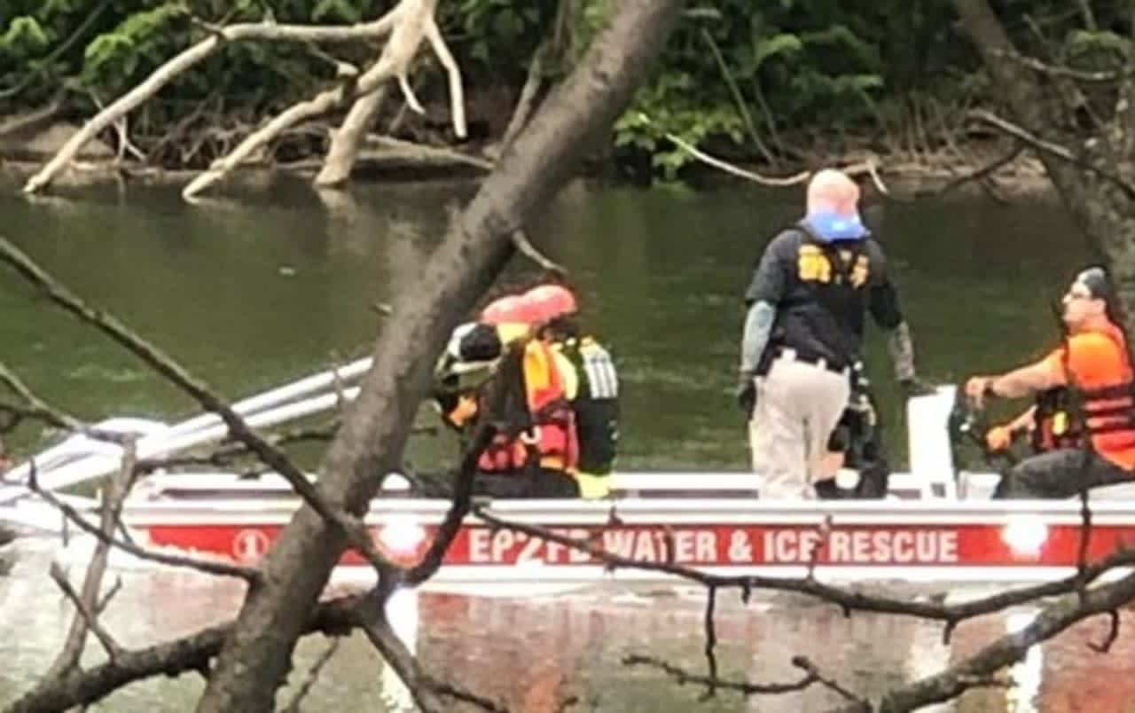 Elmwood Park firefighters return body (unseen in photo) to the shore.