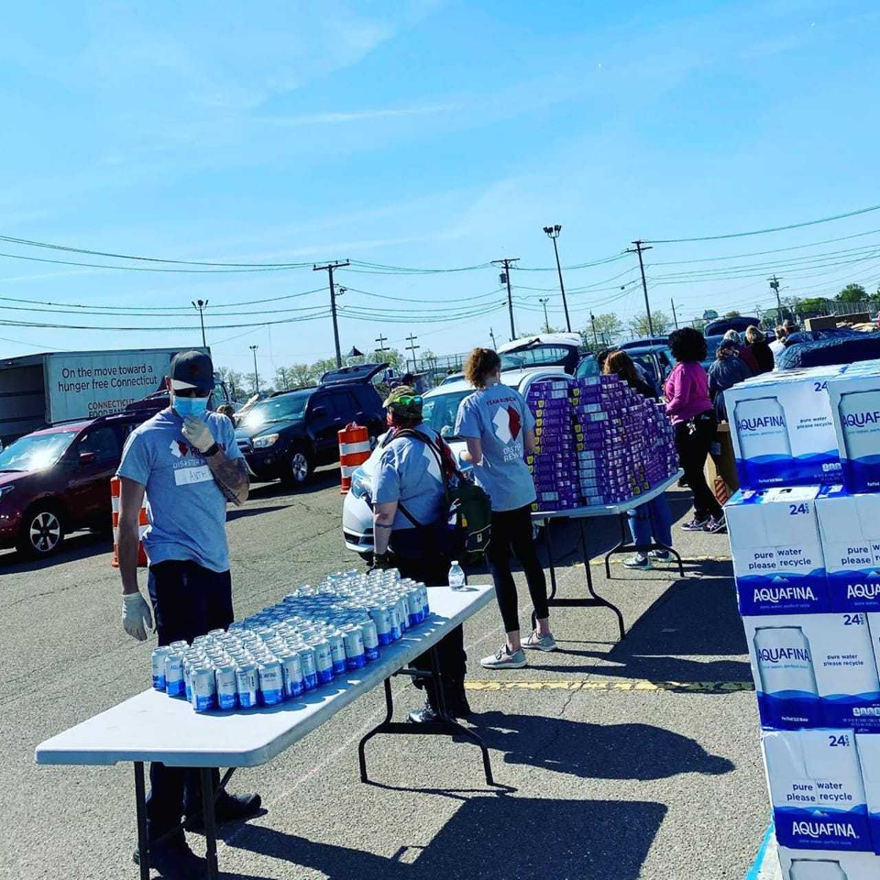 Hundreds of cars lined up to receive food during an event sponsored by the Connecticut Food Bank.