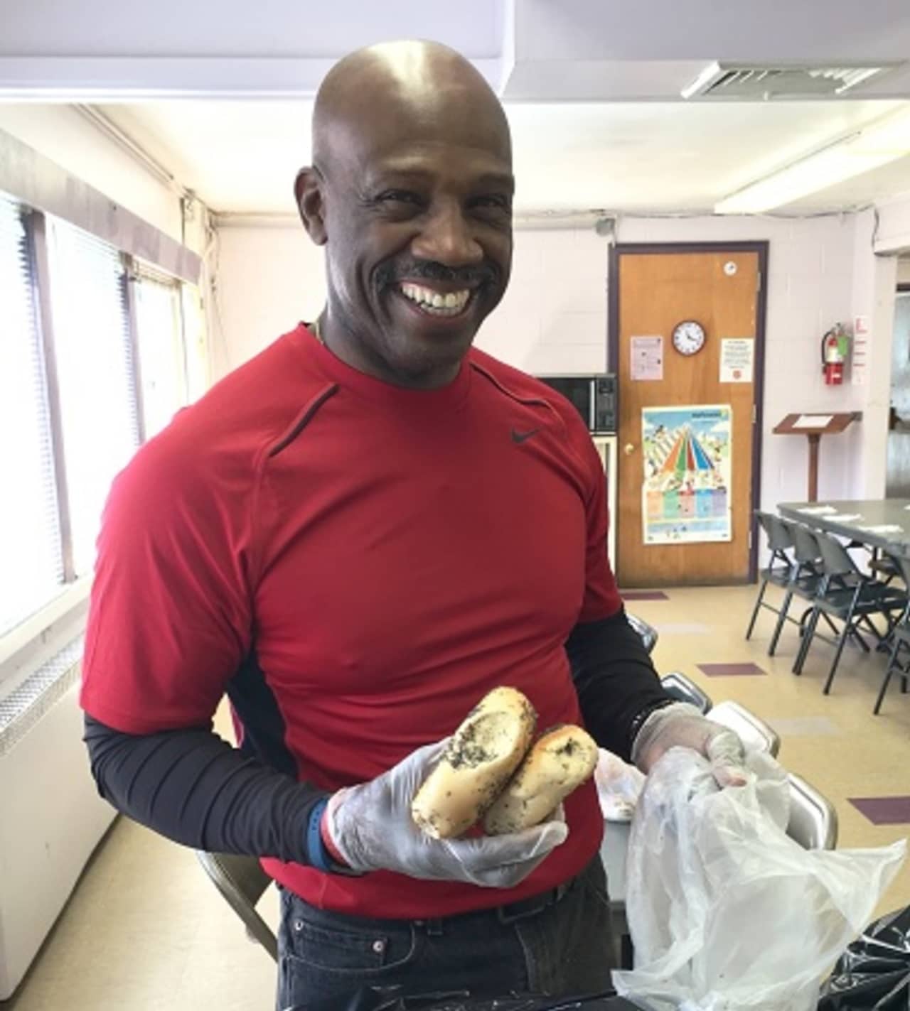Anthony Austin, a retired New York City firefighter and volunteer at the Salvation Army community center in Peekskill, bags up bagels.