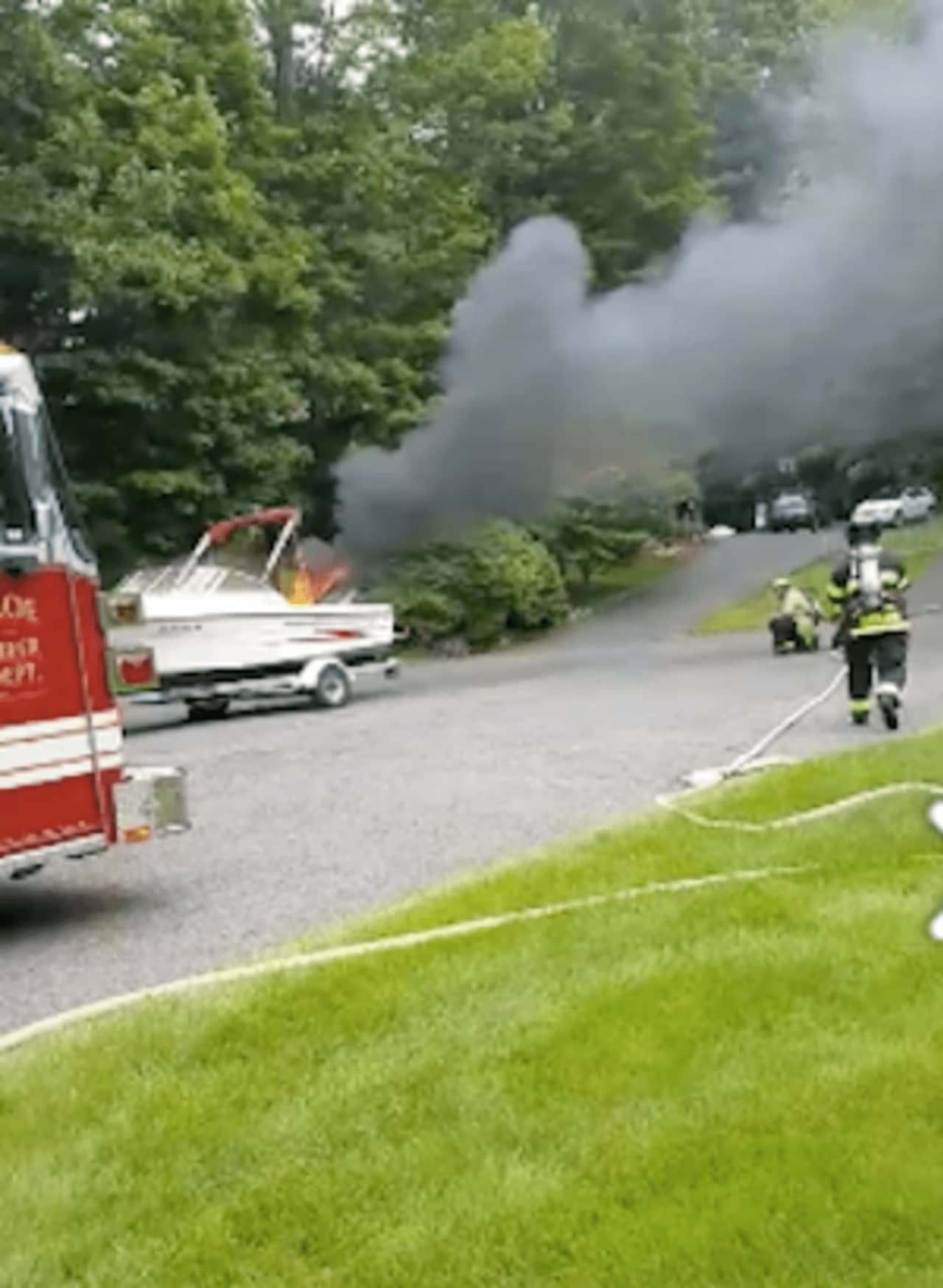 The burning boat was on a trailer at a home on Christiana Drive in Trumbull on Saturday.