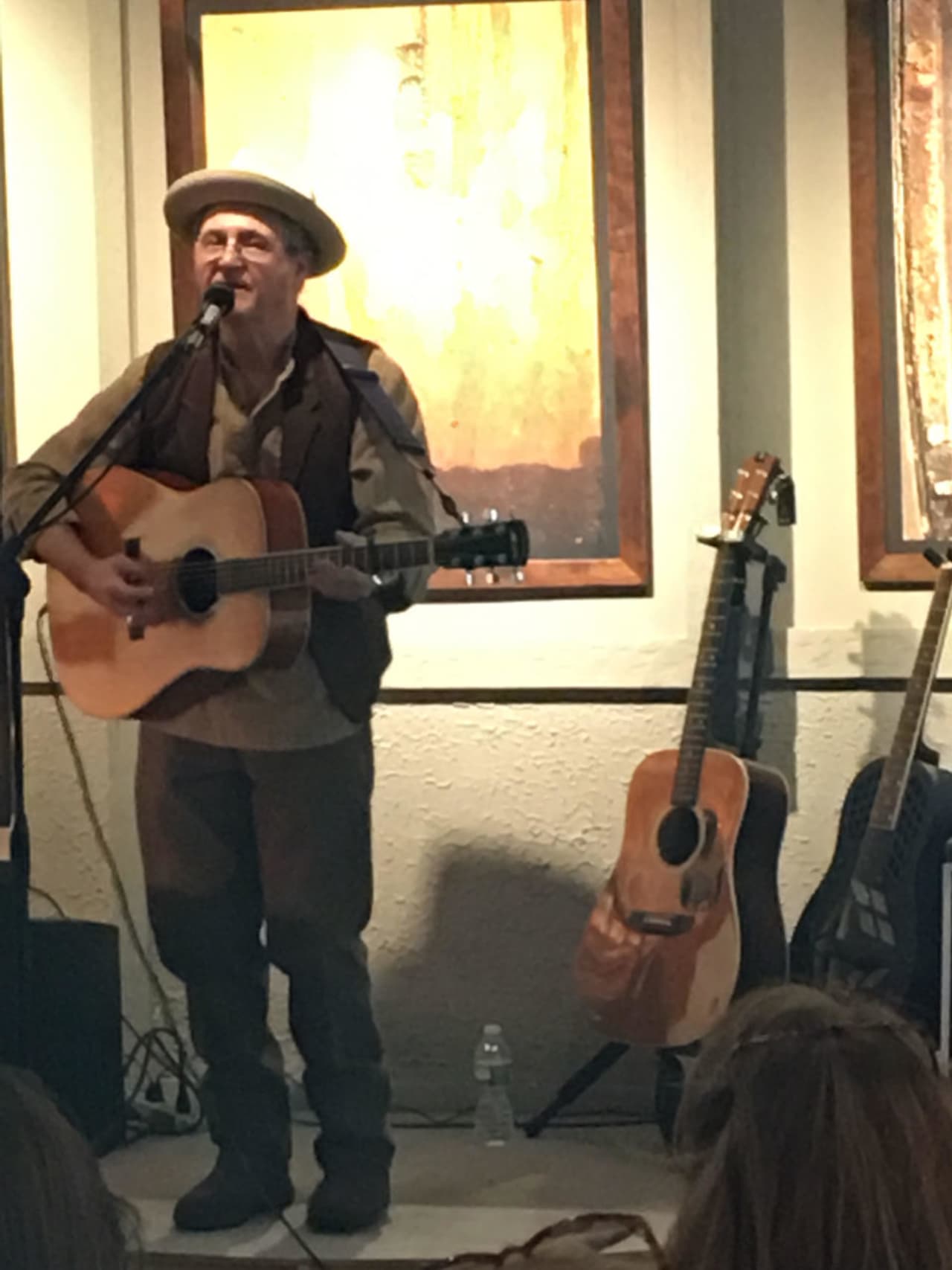 Blues musician Phil Dollard plays at a recent exhibit of photographs by Robert Olsson in Ossining.