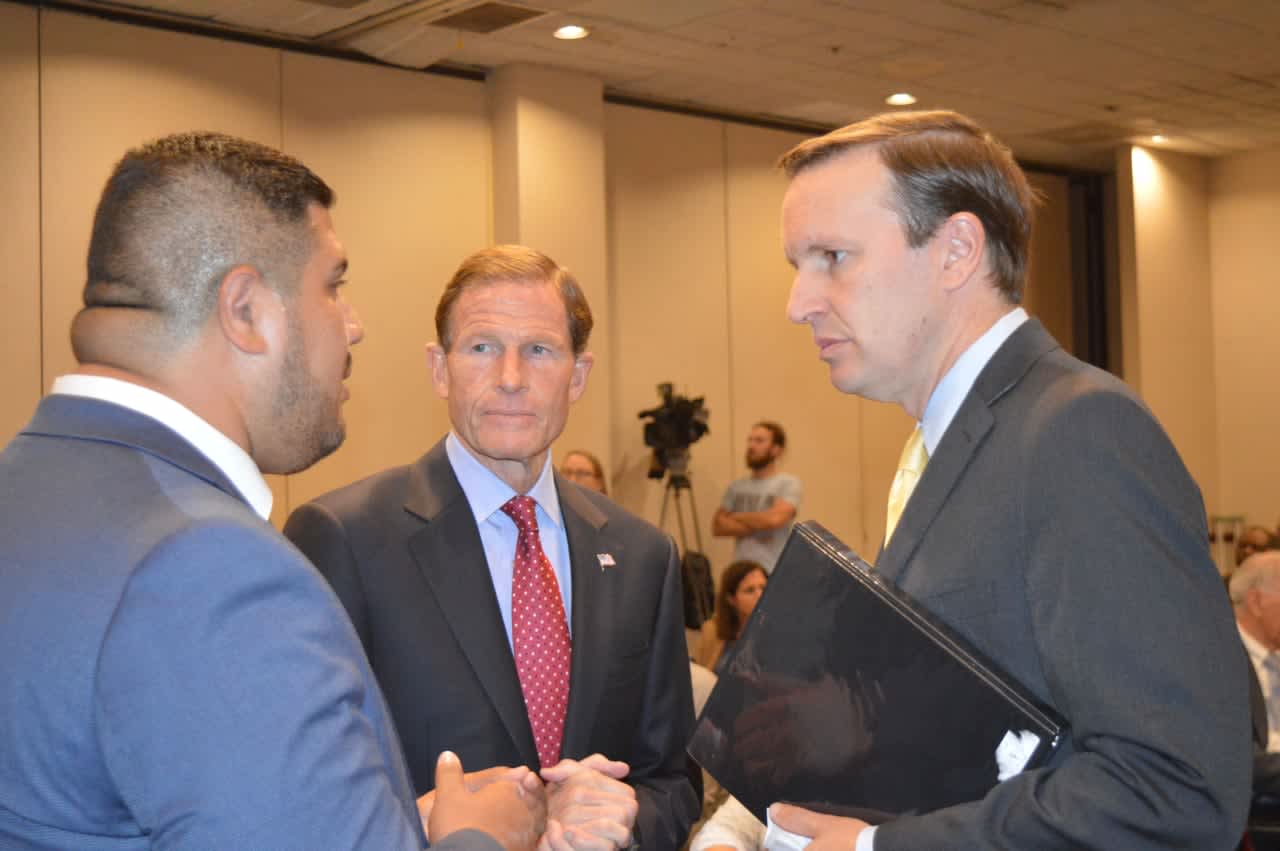 State Rep. Chris Rosario, left, speaks with U.S. Sens. Richard Blumenthal and Chris Murphy about conditions in Puerto Rico.