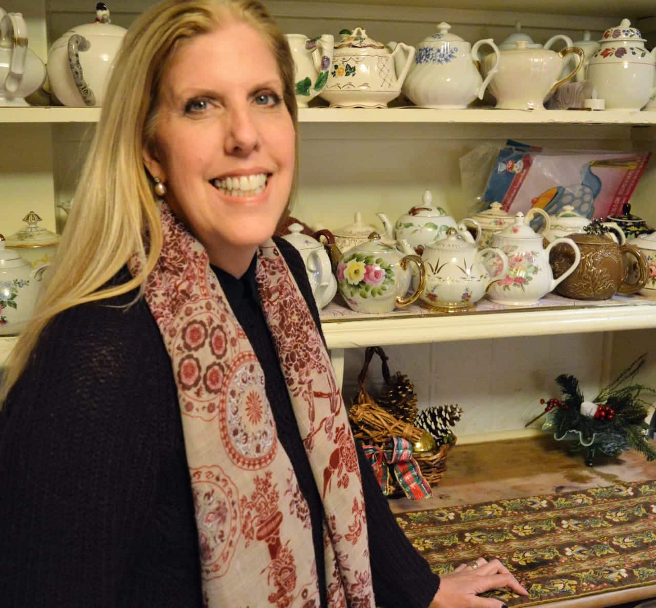 Linda Schropp with the teapot collection at the historic John Fell House in Allendale.