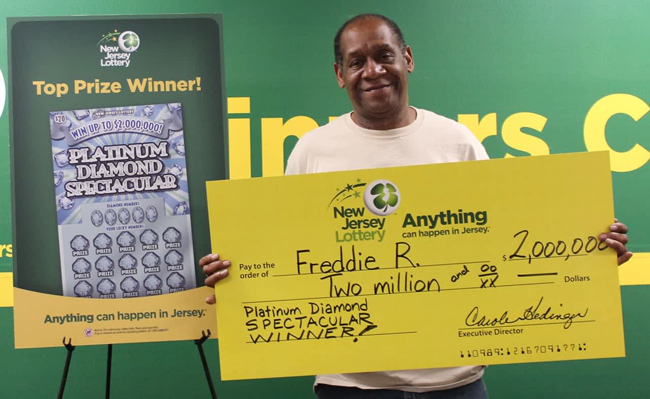 Freddie R. with a ceremonial check for his big win in 2017. He won big again playing scratch-offs last month