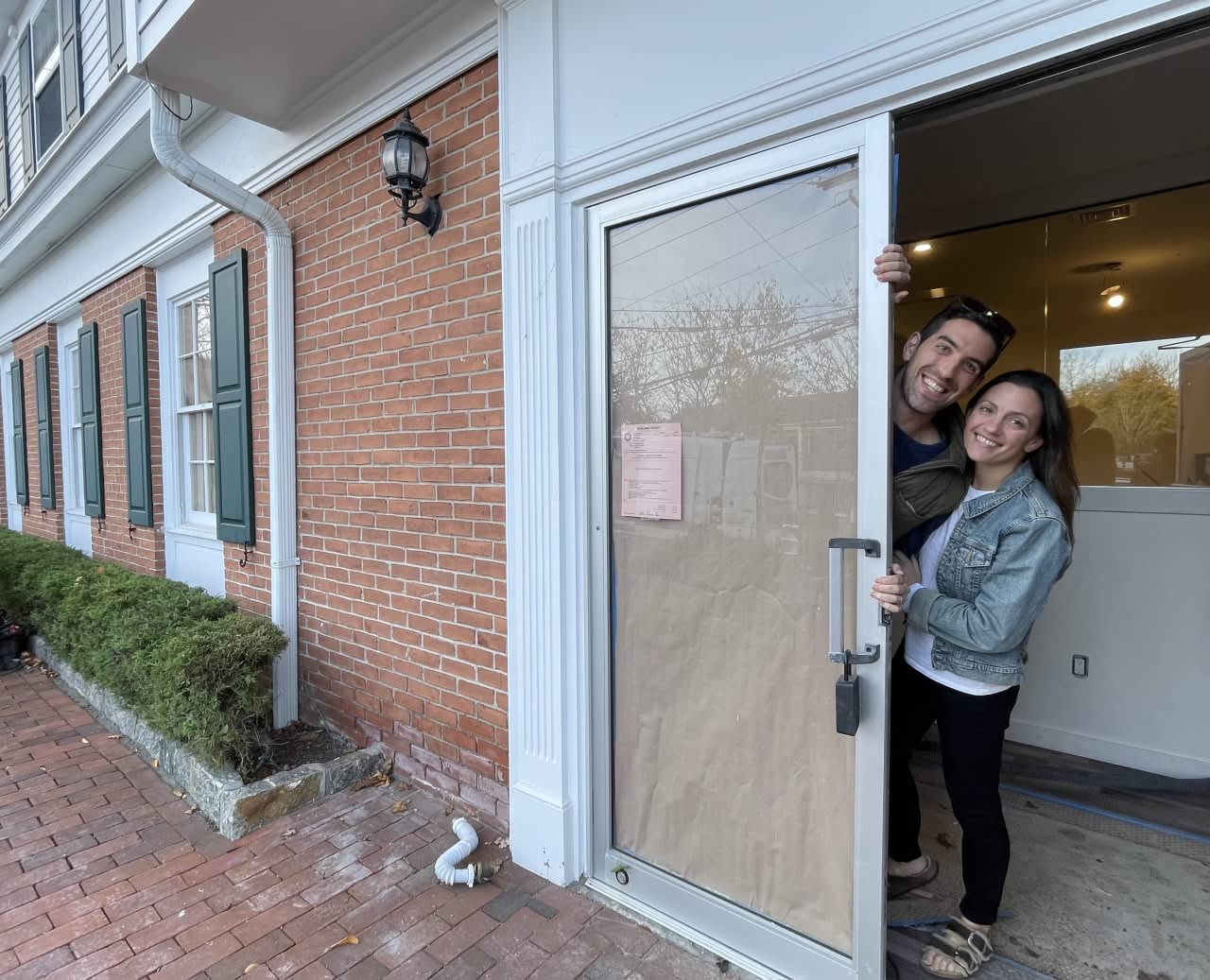 Owners Anthony and Lauren Chillemi are pictured with their business, the Bedford Village Flower Shoppe, which will soon open.