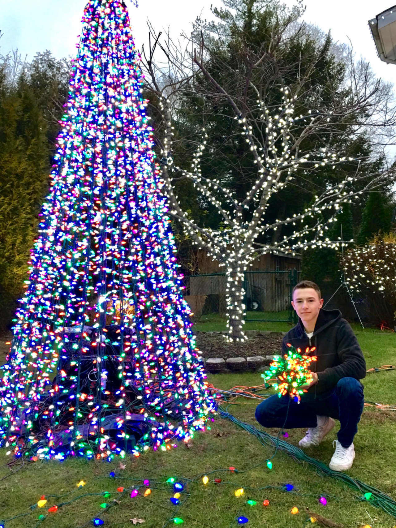 Daniel Eisenberg poses with just some of his lights in Demarest.