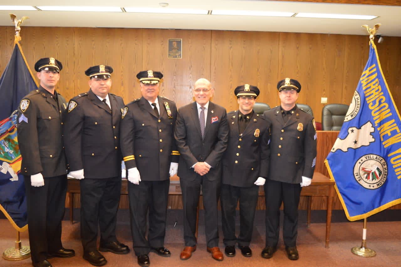 The four members of the Harrison Police Department earning promotions with Mayor Ronald Belmont and Chief Joseph J. Yasinski.