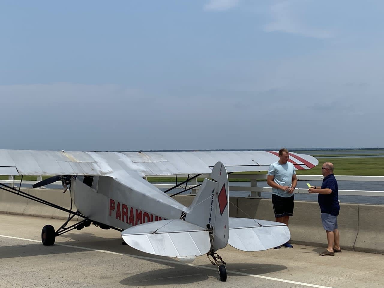 Landon Lucas (in blue) landed his banner plane in Ocean City Monday afternoon.