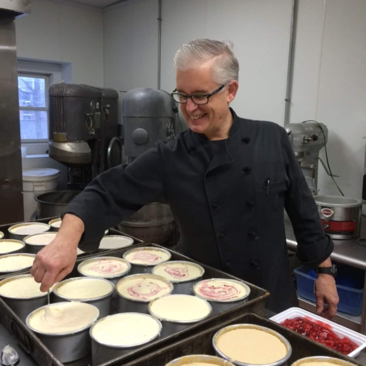 Brian Stockbridge prepares a tray of cheesecakes at Dee's Kitchen of Shelton.
