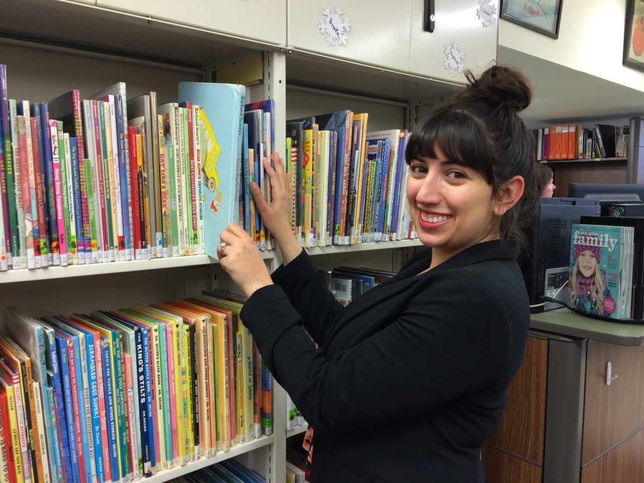 Emily Macleod sorts through children's books at the Bloomingdale Free Public Library.