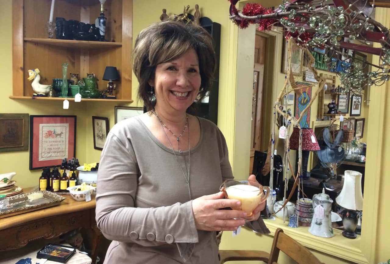 Trinkets and antiques surround Lori Pickail at her Ringwood store Wallflower Antiques.