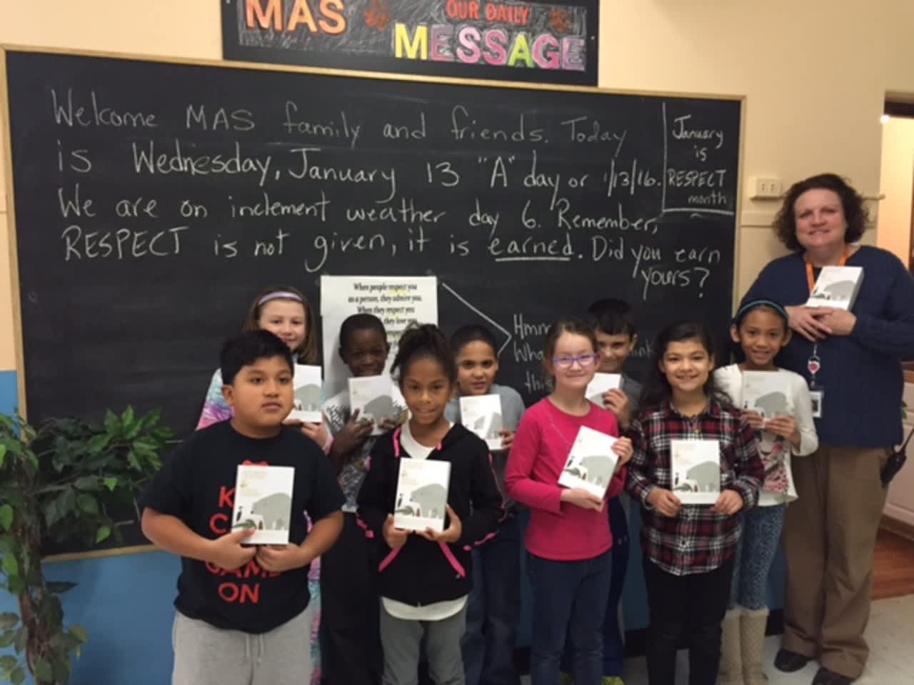 Some of Mamaroneck Avenue’s students with their principal, Eileen McGuire, and their dictionaries.