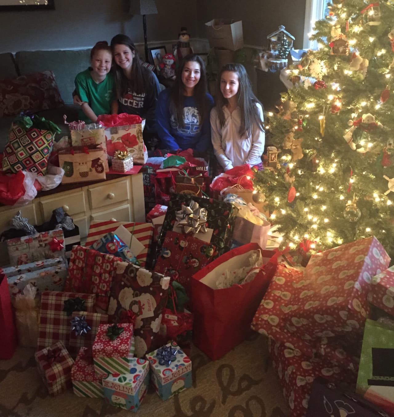 Remi Presky, surrounded by donated gifts, spends Christmas with the Sheehan family.