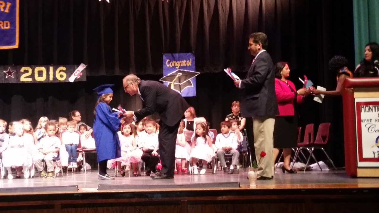 James Cassella congratulates a graduating student while Joel Brizzi looks on.