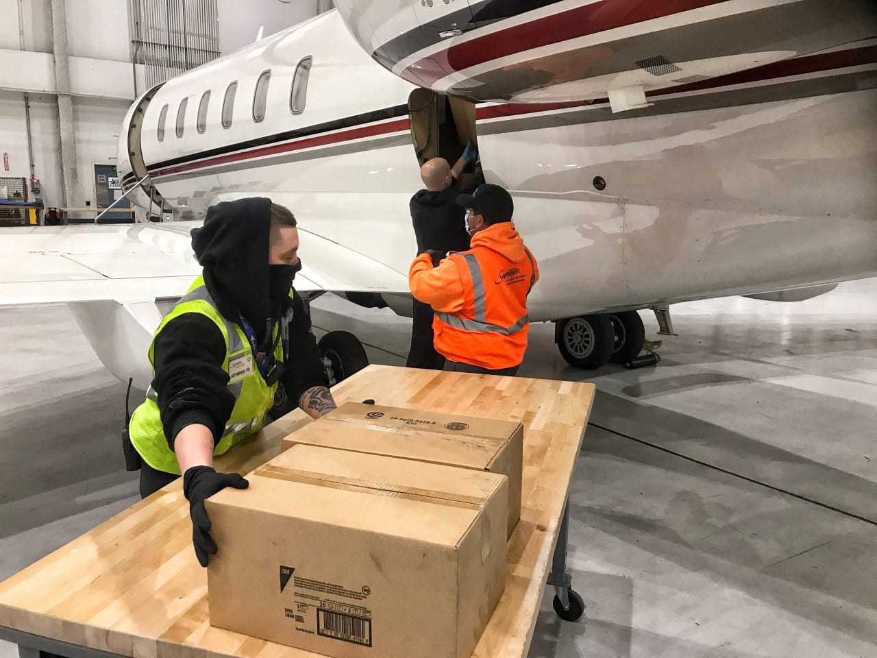 Crew members with Signature Flight Support (South) received and unloaded the shipment Tuesday morning at Teterboro.