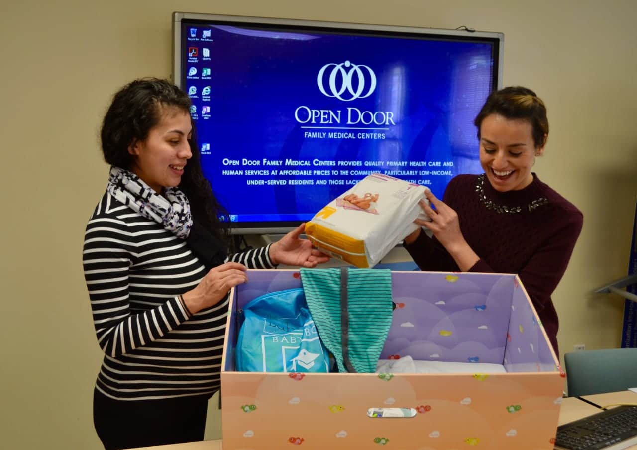 “At the Open Door Family Medical Center in Ossining on March 7, Community Coordinator Alaina Betancourt (right) reviews the contents of
the Open Door Baby Box with expecting mom Ana Ardon.”